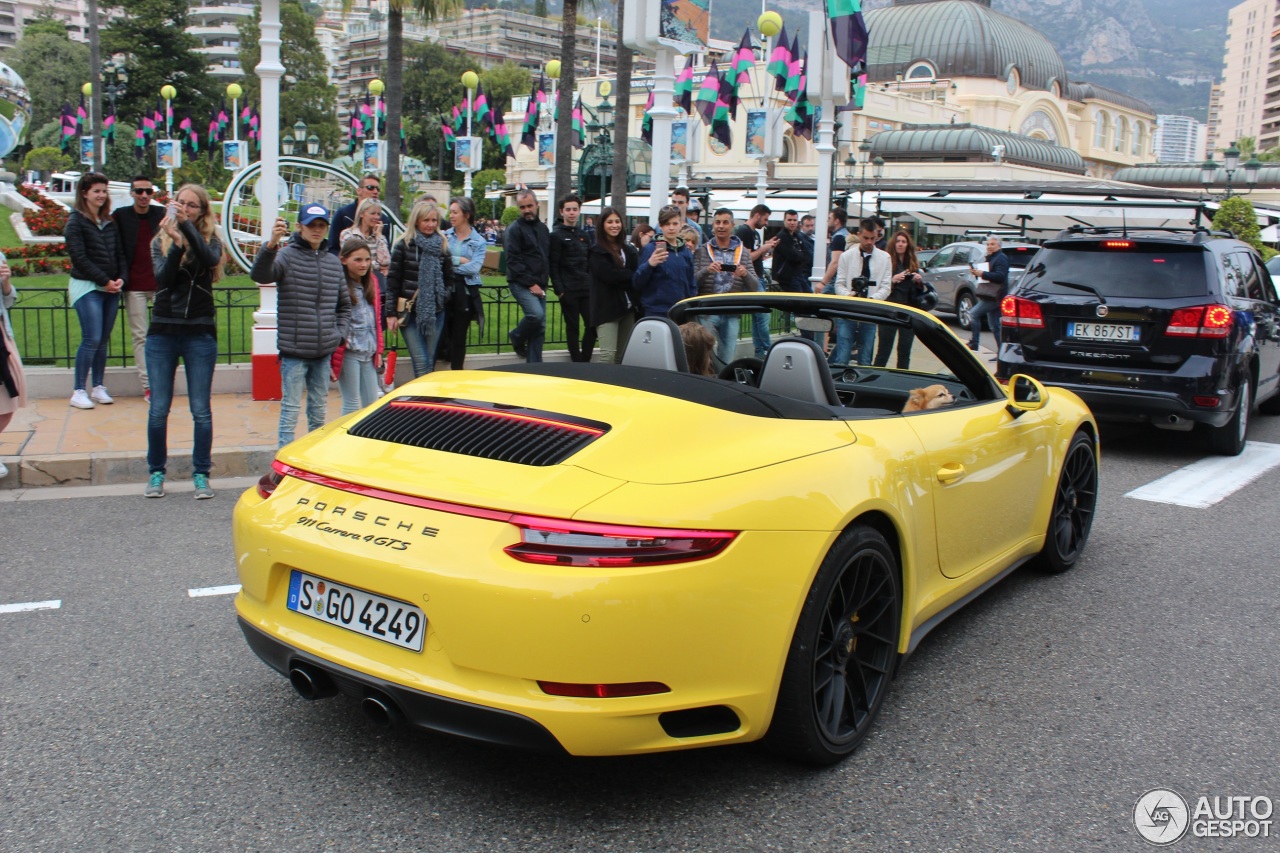 Top Marques Monaco 2017 - Racing yellow Porsche 911 Carrera 4 GTS Cabriolet and dog